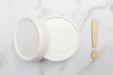 Fototapeta na wymiar Hand, face and body cream and exclamation mark. Skin care rules. Flat lay. Top view.
