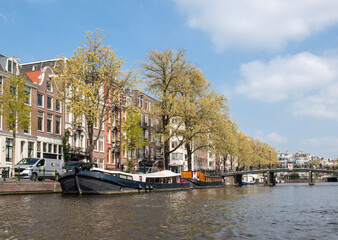 Fototapeta na wymiar Traditional historic Dutch gable houses beside canal in Amsterdam The Netherlands