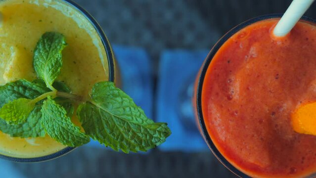 Papaya and mango smoothies with mint leaf on restaurant table