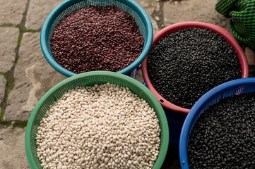 white, red, and black beans in colander