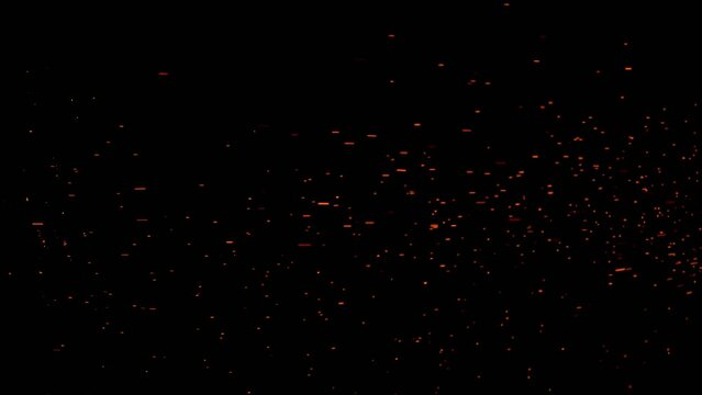 Burning red hot sparks rise from large fire in the night sky