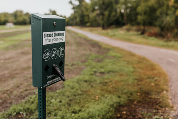 Dog waste station on the side of walking trail outside