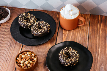 donut in chocolate glaze and nut sprinkles