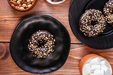 donut in chocolate glaze and nut sprinkles