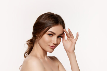 Obraz na płótnie Canvas Portrait of young beautiful woman with perfect smooth skin isolated over white background. Attraction and femininity. Concept of natural beauty, plastic surgery, cosmetology, cosmetics, skin care.