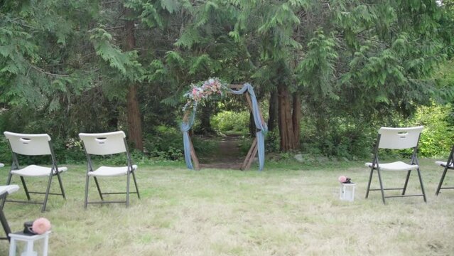 Beautiful wedding altar in the countryside. The sun is reflected in the camera. Empty chairs.