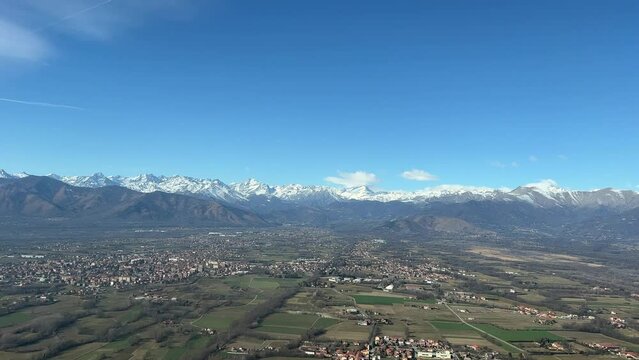 Aerial side view of the northern Italian Alps near Turin airport. Recorded from a jet cockpit during departure. Day light. Splendid winter moorning.