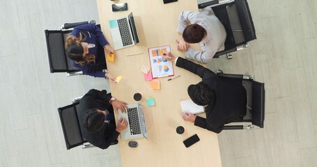 Top view of young asian businesspeople team meeting and discussing in the conference room at the office