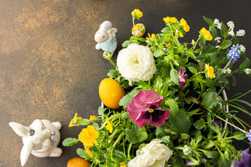 Top view of a vase with beautiful blooming flowers and Easter eggs, cute bunnies, copy space