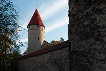 Stone tower with a red roof at sunset