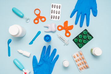 Flat lay of various medical supplies on blue background. Healthcare and medical concept