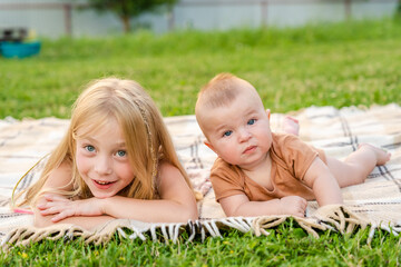 Cute childrens lying on a blanket at summer