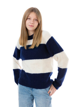 Portrait of blonde fourteen year old teenager posing in studio. Young girl in blue jeans and sweater smiling on camera isolated on white background.
