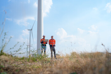 Surveyor and engineer Examine the efficiency of gigantic wind turbines that transform wind energy...