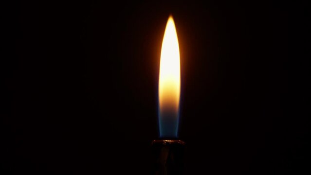 slow motion shot of a flame igniting out of a lighter on a black background