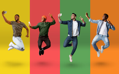 Cheerful multiethnic guys jumping and taking selfie on smartphones over colorful backgrounds