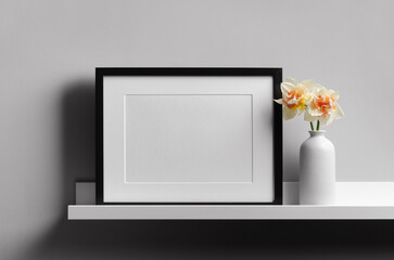 Blank landscape picture frame mockup on shelf with flowers, blank mockup with copy space