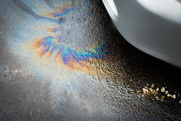 Oil stain or gasoline caused by a leak under a car.