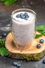 Blueberry jogurt, Homemade berry smoothie. Healthy eating. Diet food yogurt on a dark background, vertical image. top view. place for text