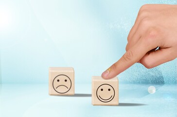 The customer hand pointed at the icon on wooden cube