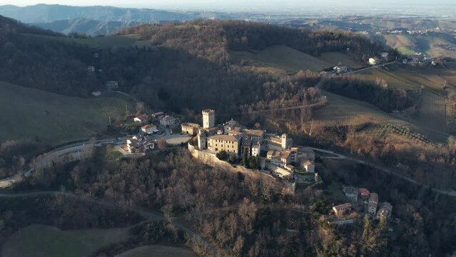 drone aeria sunsetl view of Vigoleno Castle , fortress village and hills, scenic panorama in Parma, Emilia Romagna , Italy.