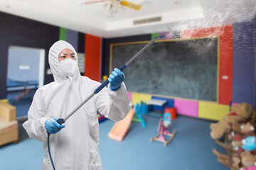 Fototapeta premium Worker wears medical protective suit or coverall suit sanitize with spray