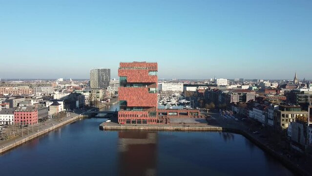 Establishing Aerial drone dolly back shot of MAS museum and het loodsgebouw (the Antwerp pilot building) in the Belgian city of Antwerpen over the river Scheldt