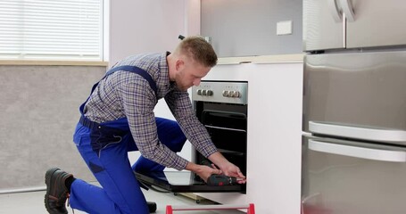 Young Man In Overall Repairing Washing