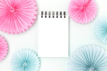 Clean notepad mockup and tissue paper fans on a blue background. Creative concept.