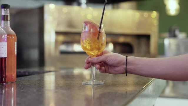 Cocktail being removed and replaced onto the restaurant bar