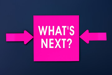 What's Next - inscription of a magenta paper notes and two colorful arrows over a dark blue...