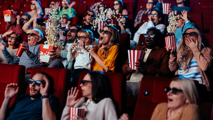 Scared people in movie theater.