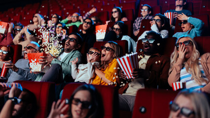 Scared audience watching 3D movie. - obrazy, fototapety, plakaty