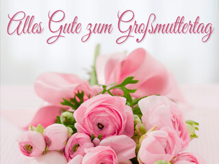 Karte oder Banner, um einen glücklichen Großmuttertag in Rosa auf einem grauen Hintergrund mit Bokeh-Effekt und unter einem Strauß rosa Blumen zu wünschen