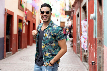 Mexican man traveling in Guanajuato. Student exploring a colorful city. 