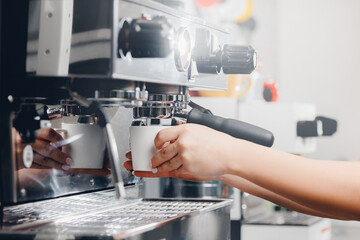 Close up process of preparation coffee latte art drink on machine, espresso is poured into cup