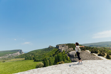 a woman on a hike with a backpack stands on the road hiking nature journey