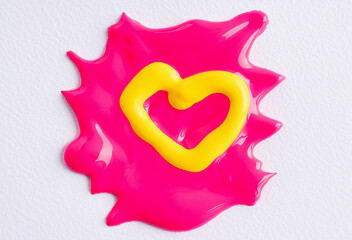 Yellow heart on a pink paint splatter. Abstract heart