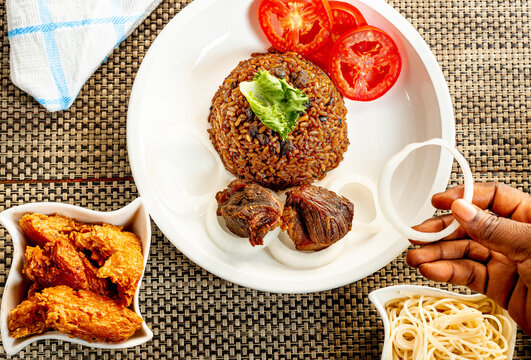 jollof with red chili paste and chicken and meat