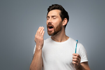 Middle aged man holding hand near mouth and checking breath freshness, worrying about poor oral hygiene - obrazy, fototapety, plakaty