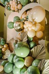 Arch decorated green, brown golden balloons, big paper decor leaves for wedding ceremony....