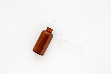 Face serum essential oil in dropper bottle top view