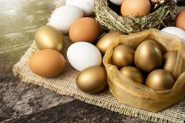 golden color eggs and regular ones. Easter banner space for text,  concept of enrichment and wealth