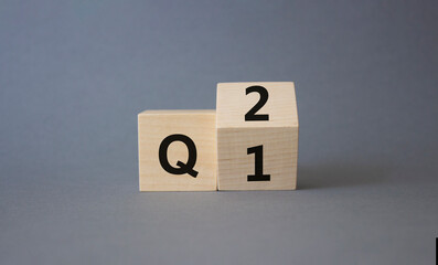 From 1st Quarter to 2nd symbol. Turned wooden cubes with words 1st Quarter and 2nd Quarter....