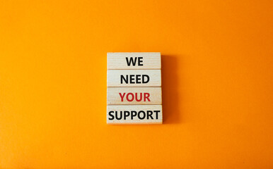 We need your support symbol. Wooden blocks with words We need your support. Beautiful orange background. Business and We need your support concept. Copy space.