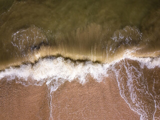 Aerial view of a stormy sea with bizarre waves and sandy beach, scenic seascape, outdoor travel background, summer holidays concept, Azov sea, Ukraine