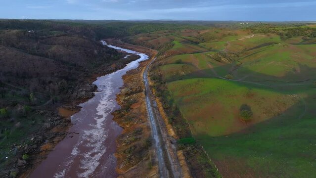 Landscape behind the rain in the Rio Tinto. Aerial view from a drone in the surroundings of the town of La Palma del Condado. Sierra Morena, Gulf of C&aacute;diz, Huelva, Andalusia, Spain, Europe