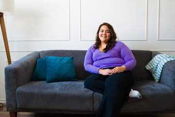 Obraz premium Portrait of a happy obese woman relaxing at home