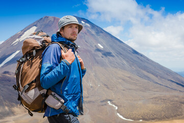 Fototapeta premium Young adult backpacker hiking in New Zealand. Tongariro national park