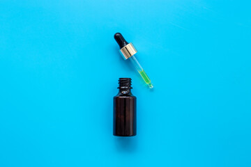 Face serum essential oil in dropper bottle top view